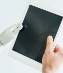 robot and human hand holding blank tablet_sm robot and human hand holding blank tablet_sm